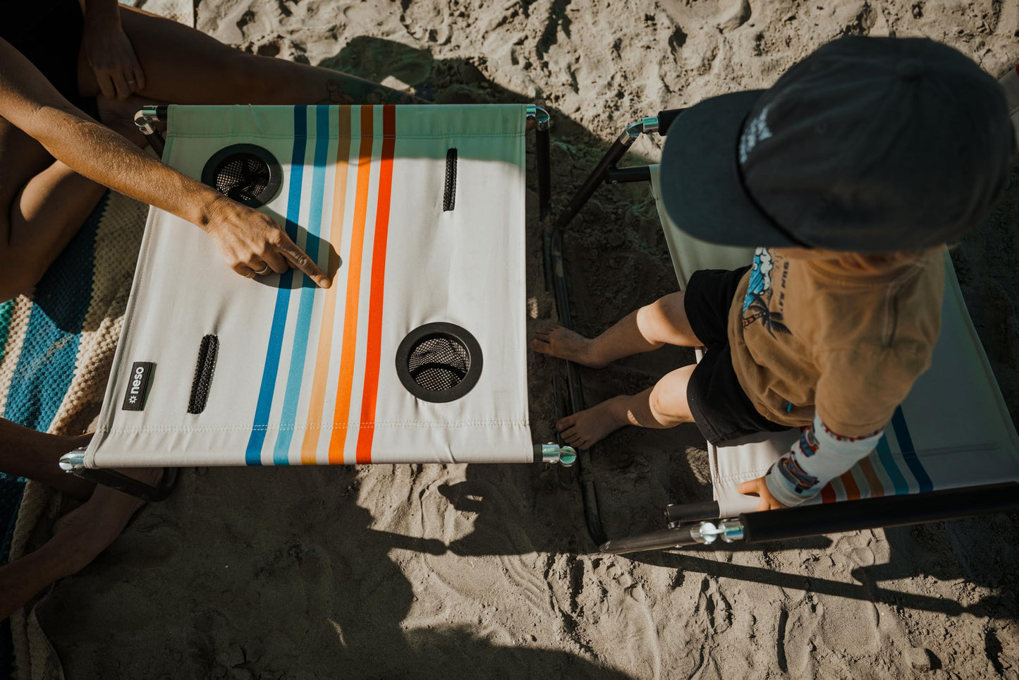 Neso Portable Beach Table with Cup Holders, Cell Phone Pockets, Lightweight for Picnics and Parks (Rainbow)